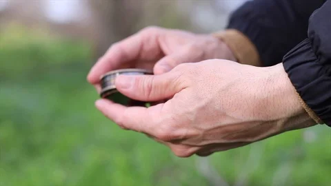 Hands using a compass in the field Stock Footage 128984687
