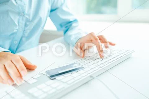 Hands using computer and credit card on it Stock Photos
