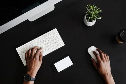 Hands Using Computer on Black 写真素材
