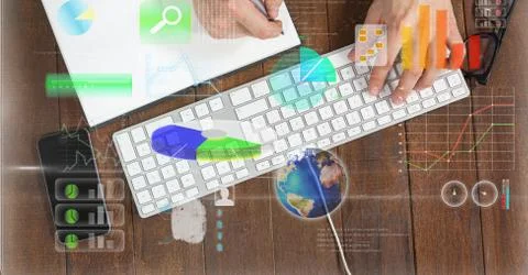 Hands using computer keyboard with graph overlays Stock Photos
