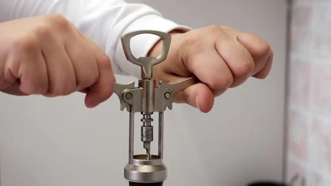Hands Using Corkscrew to Open Wine Bottle Close Up. Stock-Footage 346861864
