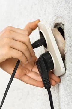 Hands using dangerous broken electric socket Stock Photos