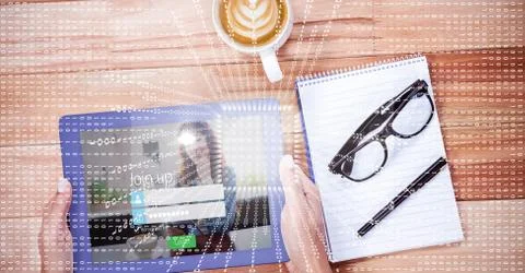 Hands using digital tablet by book and coffee cup 写真素材