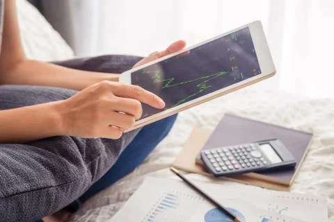 Hands using digital tablet, checking investment graph. Stock Photos