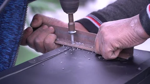 Hands Using a Drill on Metal Stock Footage 315787328