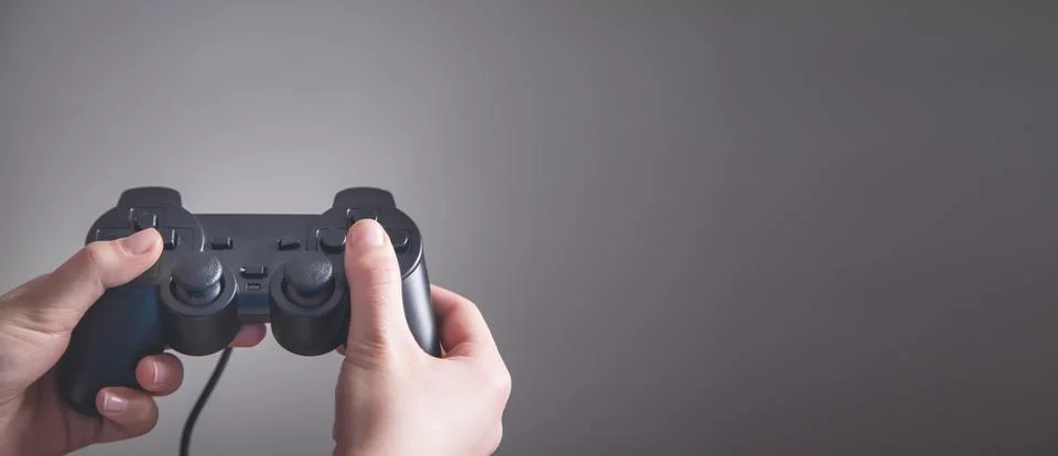 Hands using game controller. Playing video games Stock Photos