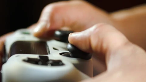 Hands Using A Gaming Controller While Playing A Video Game Vídeos de archivo 63160734