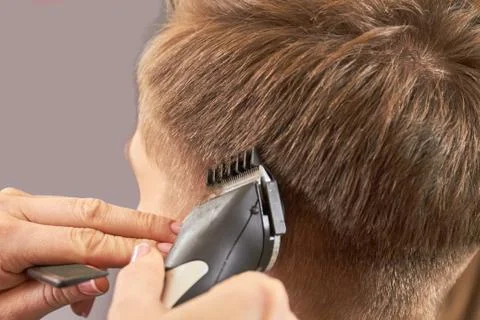 Hands using hair clipper. Stock Photos