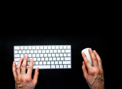 Hands using keyboard and mouse on office black leather desk Stock Photos
