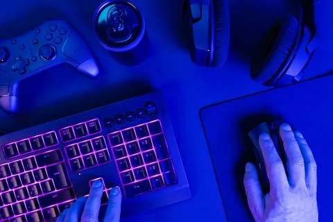 Hands using keyboard with mouse while gaming Stock Photos
