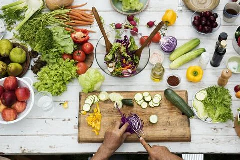 Hands using knife cutting a red cabbage Stock Photos