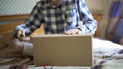 Hands using knife to open the delivered package  at home Stock Footage 96493364
