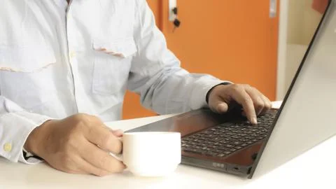 Hands using laptop and drinking coffee for online shopping 写真素材