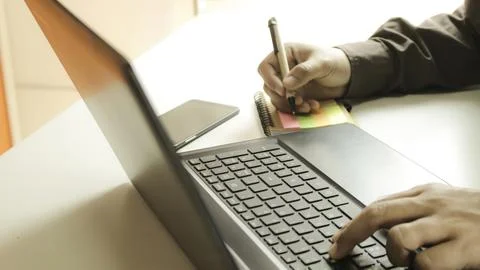 Hands using laptop and smartphone for online shopping with daytime soft lig.. Stock Photos