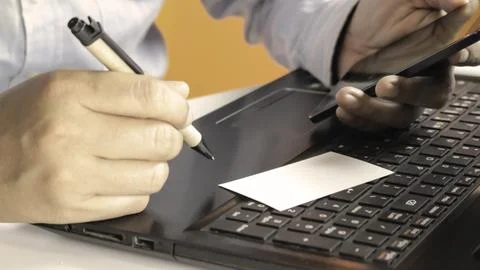 Hands using laptop and smartphone check business cards for calling online s.. Stock Photos