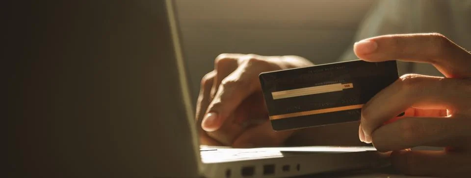 Hands using laptop computer and holding credit card at working desk for onl.. Stock Photos