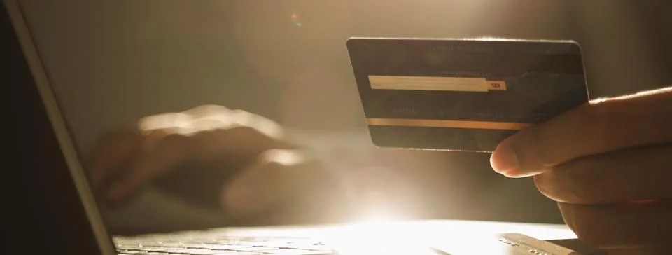 Hands using laptop computer and holding credit card at working desk for onl.. Stock Photos
