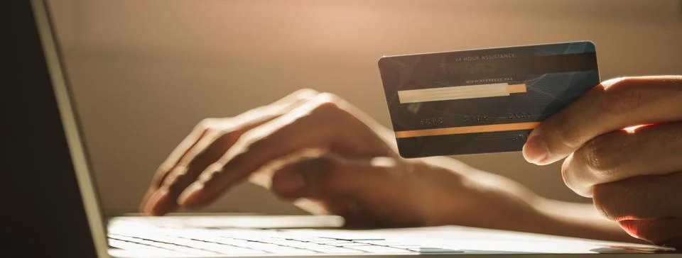 Hands using laptop computer and holding credit card at working desk for onl.. Stock Photos