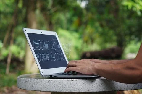 Hands Using Laptop in Natural Environment with Graphic Elements Stock Photos