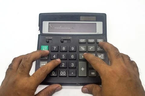 Hands using a large calculator with a broken display on a white background,.. Stock Photos