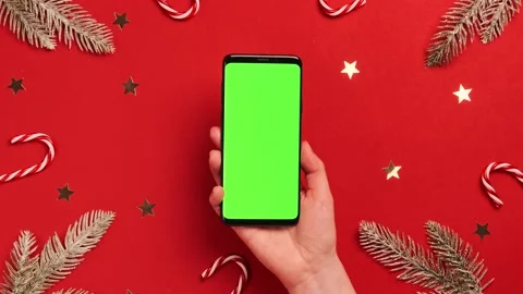 Hands using mobile phone with green screen on Christmas background Stock Footage 144137900