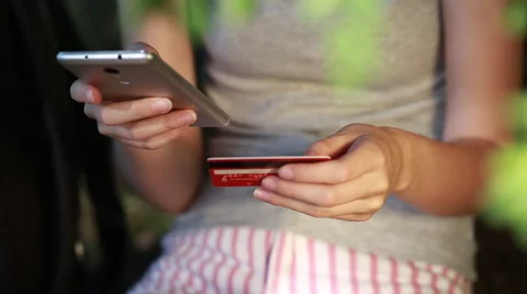 Hands using mobile smart phone and holding credit card outdoor Online shopping Stock-Footage 67397524