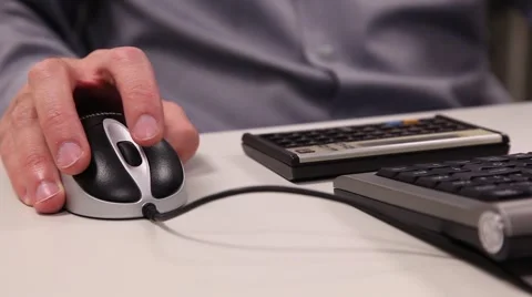 Hands using mouse and a calculator Stock Footage 46531331