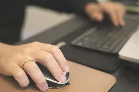 Hands Using Mouse And Keyboard At Desk Stock Photos