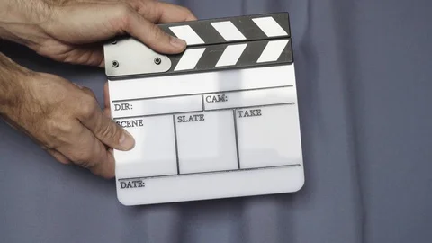 Hands using movie production clapper board Stock Footage 99913529
