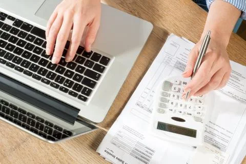 Hands using Pen, Calculator and Computer for Accounts Stock Photos