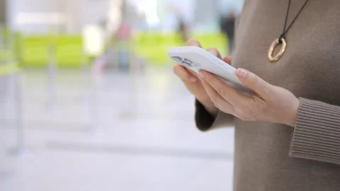 Hands using phone in bright indoor area Stock Footage 342063761