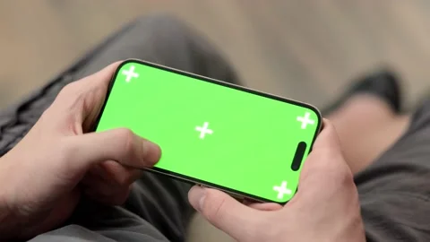 Hands using phone with chroma key green screen at home, advertising apps, games 動画素材 232956915