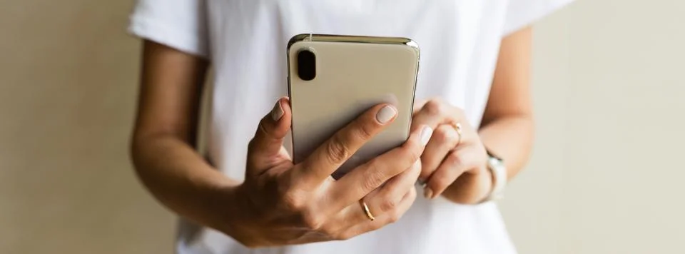 Hands using a phone texting on smartphone app, searching or social networks c Stock Photos