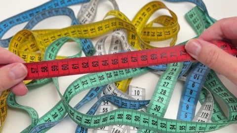 Hands using a red measuring tape to check measurements Stock Footage 336626981
