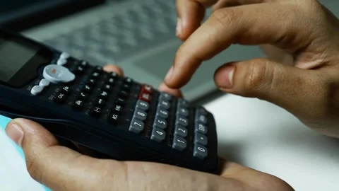 Hands Using Scientific Calculator with Laptop, Close-up of hands using a sc.. Stock Footage 304961012