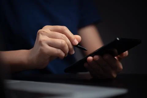 Hands using smart pen and working with laptop. Stock Photos