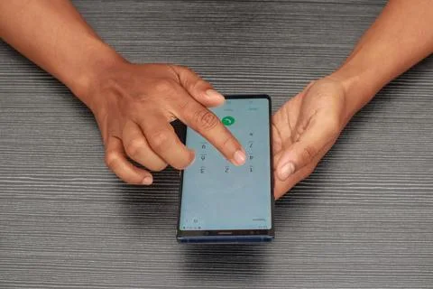 Hands Using Smartphone With Blurred Textured Background and Sunlight Stock Photos