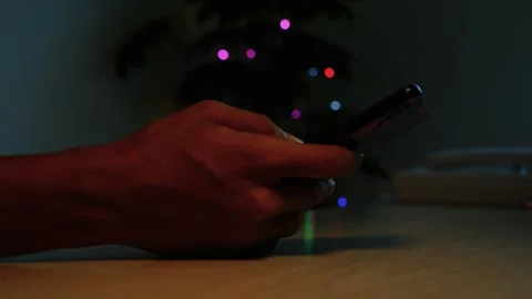 Hands using a smartphone in a dark room, Close-up of a person holding a sma.. Stock-Footage 346484587