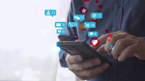 Hands using smartphone with floating social media icons showing likes messag Stock Footage 319642211