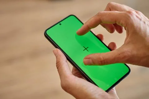Hands using smartphone with green screen Stock Photos