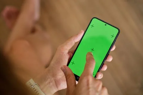 Hands using smartphone with green screen Stock Photos