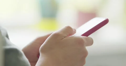 Hands using smartphone with red case for apps, communication, and internet Stock Footage 277596340