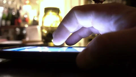Hands using a smartphone to send messages inside a pub at night Stock Footage 304972573