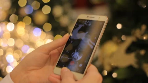 Hands Using Smartphone Shooting Christmas Video With At The Party. Closeup. Video stock 99716090