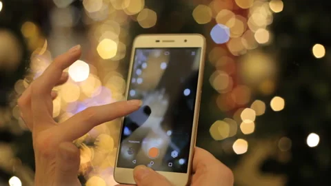 Hands Using Smartphone Shooting Christmas Video With At The Party. Closeup. Video stock 99716198