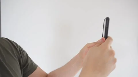 Hands using a smartphone to take a photo on a white background Stock Footage 285355495