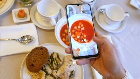 Hands using smartphone taking photos of chicken pasta with tomato coup and slice 스톡 동영상 125072522