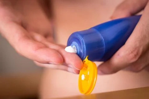 Hands using sun cream. Sun protection for avoiding sunburn Stock Photos