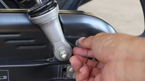Hands using T - socket wrench insert the bolt, chain cover, motorcycle Stock Footage 145859520
