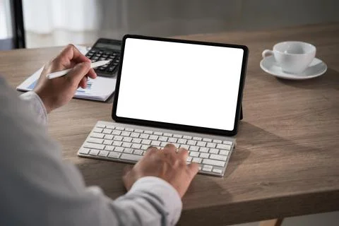 Hands using tablet with blank screen mockup and keyboard on desk with calcu.. Stock Photos